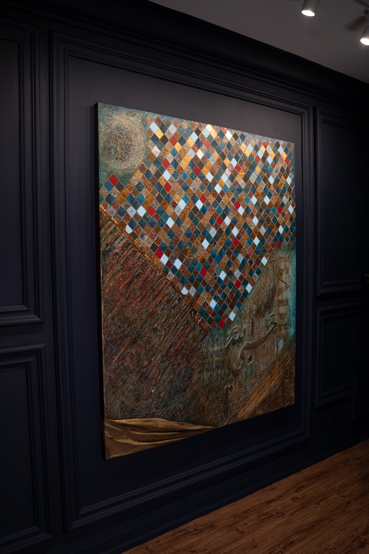 Battle of Badr Islamic painting on a dark gallery wall, angled view