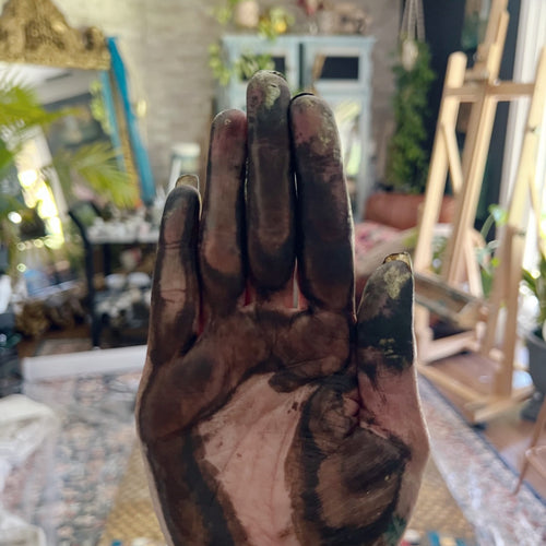 Paint-covered hand in Saleha Contractor's studio