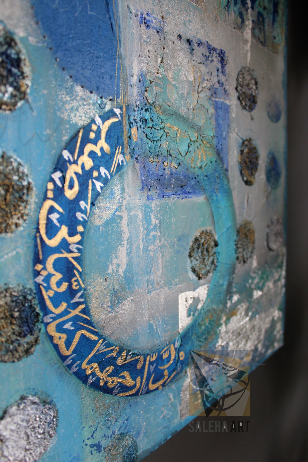 Close-up of the blue circular Dua calligraphy (Quran 25:74) on the original painting